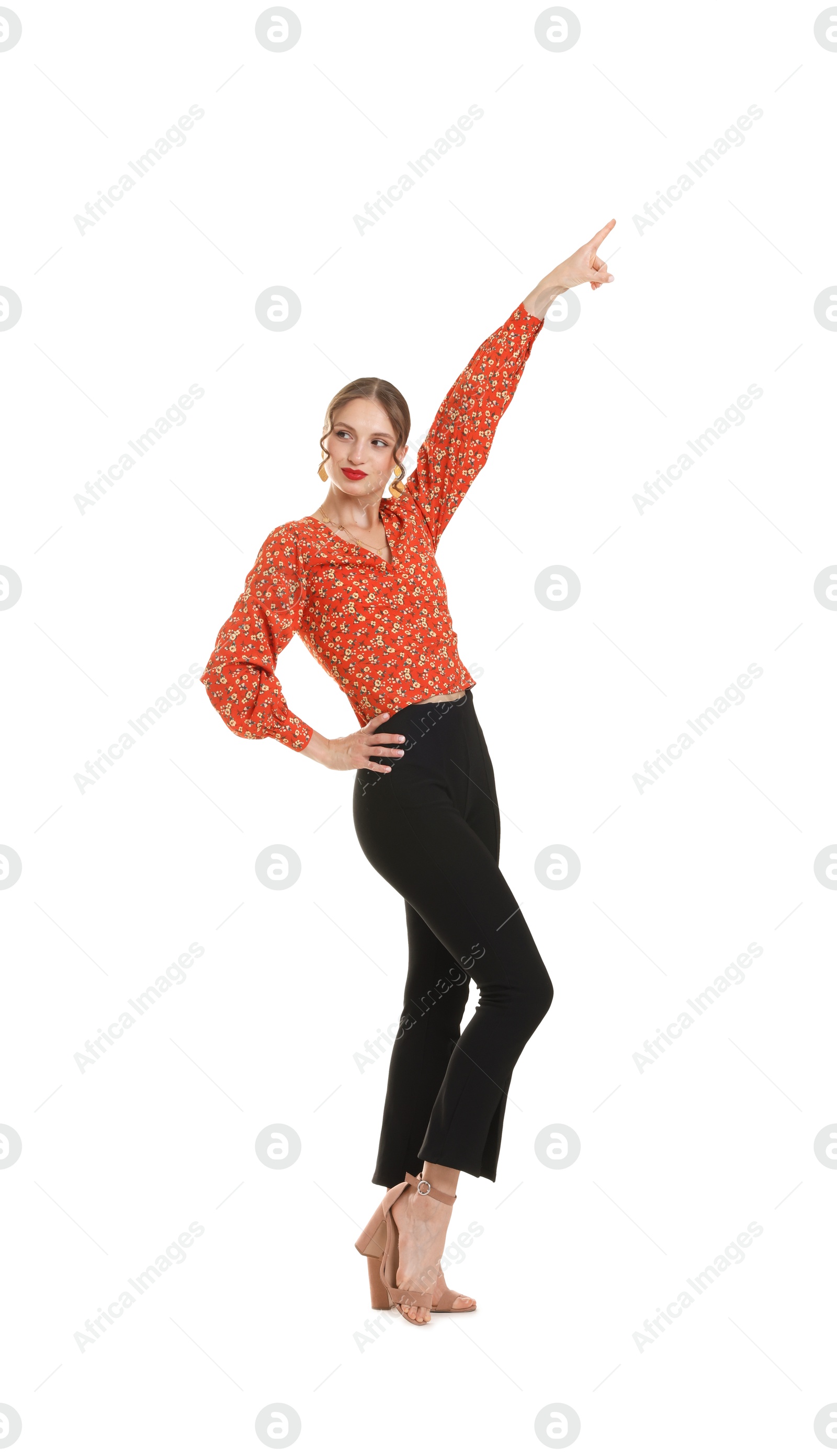 Happy young woman in retro outfit dancing on white background Photo of Happy young woman in retro outfit dancing on white background