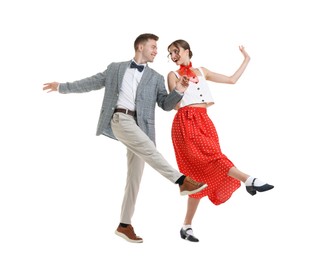 Photo of Happy couple in retro outfits dancing on white background