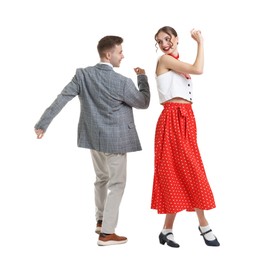 Photo of Happy couple in retro outfits dancing on white background
