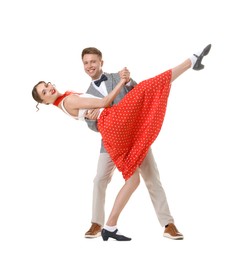 Photo of Happy couple in retro outfits dancing on white background