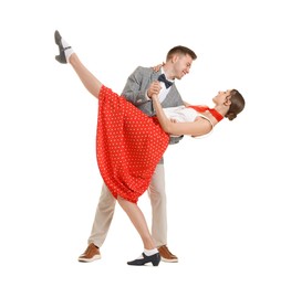 Photo of Happy couple in retro outfits dancing on white background