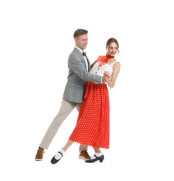 Photo of Happy couple in retro outfits dancing on white background