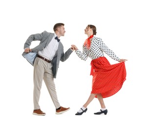 Photo of Happy couple in retro outfits dancing on white background