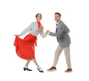 Photo of Happy couple in retro outfits dancing on white background