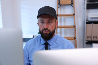 Photo of Security guard monitoring CCTV cameras in office