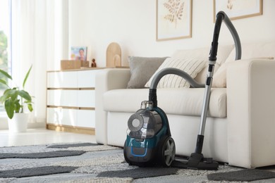 Photo of One vacuum cleaner on floor indoors. Household appliance