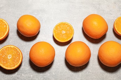 Photo of Fresh ripe oranges on grey table, flat lay