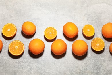 Photo of Fresh ripe oranges on grey table, flat lay