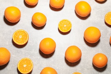 Photo of Fresh ripe oranges on grey table, flat lay