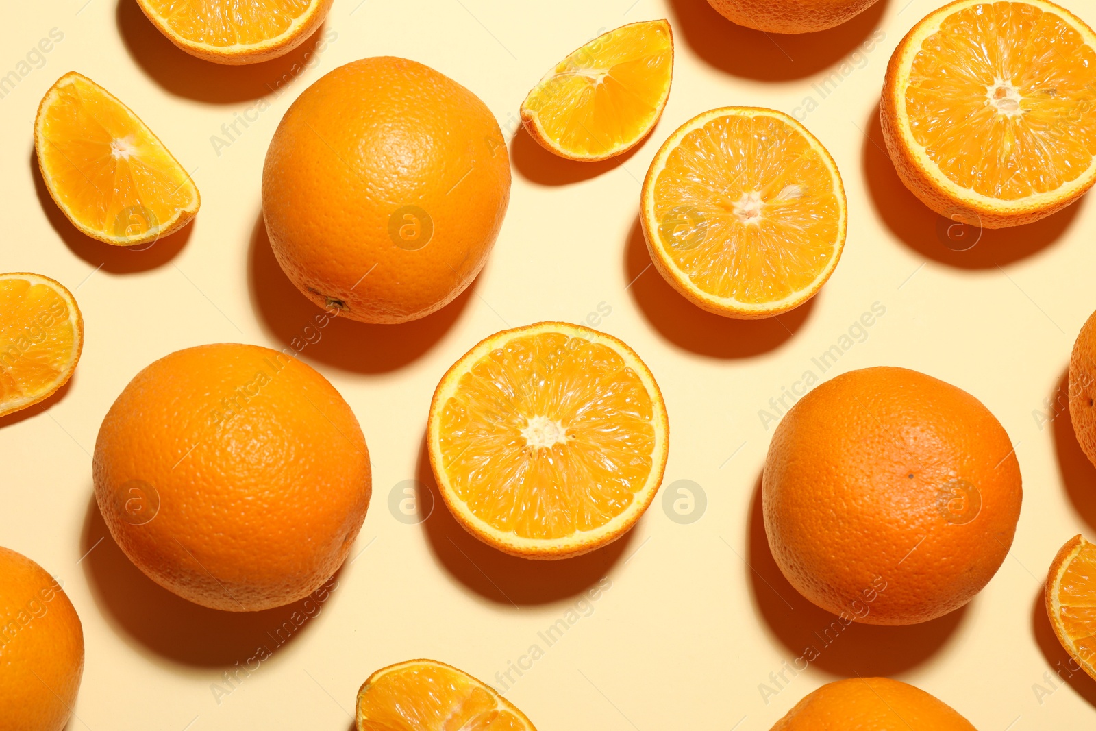 Fresh ripe oranges on beige background, flat lay Photo of Fresh ripe oranges on beige background, flat lay