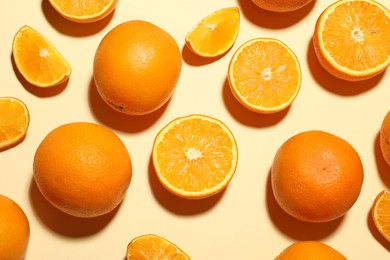 Photo of Fresh ripe oranges on beige background, flat lay