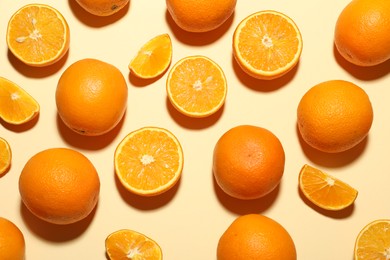 Photo of Fresh ripe oranges on beige background, flat lay