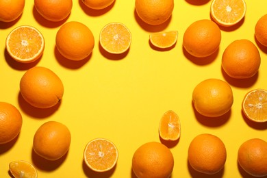 Photo of Fresh ripe oranges on yellow background, flat lay. Space for text