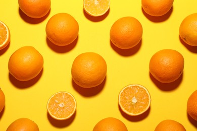 Photo of Fresh ripe oranges on yellow background, flat lay