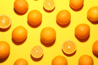 Photo of Fresh ripe oranges on yellow background, flat lay