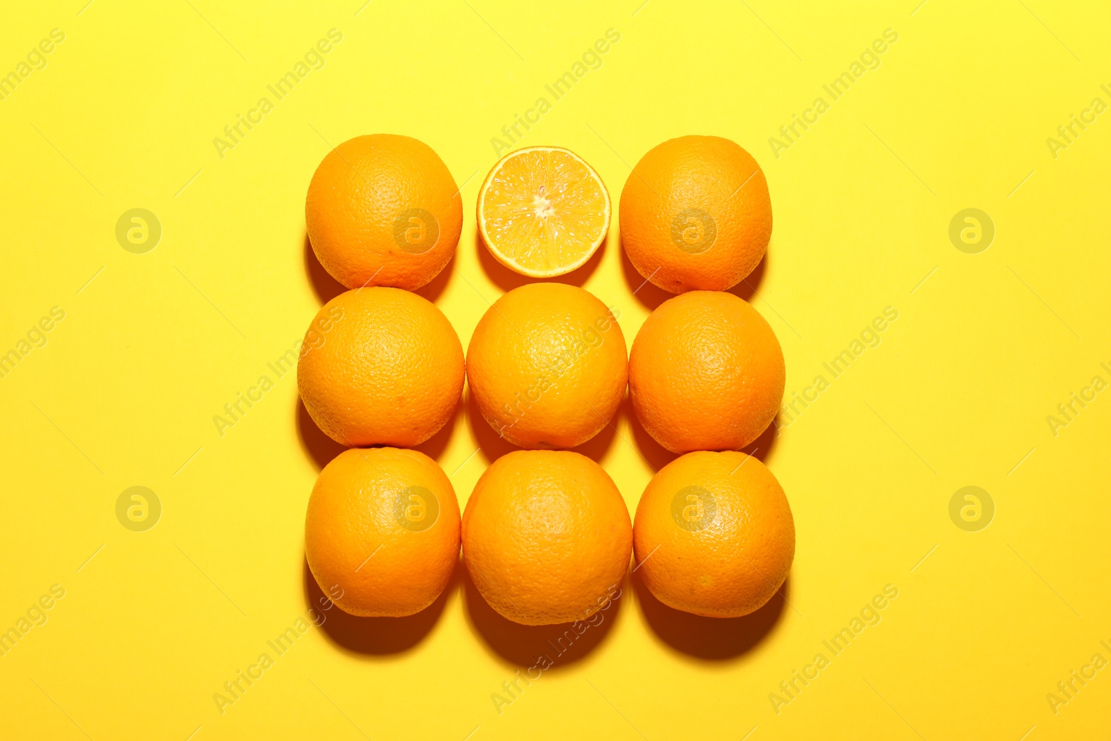 Fresh ripe oranges on yellow background, flat lay Photo of Fresh ripe oranges on yellow background, flat lay
