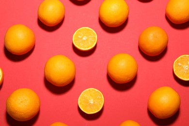 Photo of Fresh ripe oranges on red background, flat lay