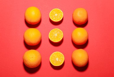 Photo of Fresh ripe oranges on red background, flat lay