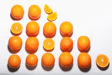 Photo of Fresh ripe oranges on white background, flat lay