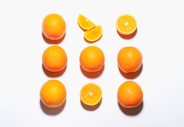 Photo of Fresh ripe oranges on white background, flat lay