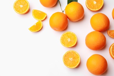 Photo of Fresh ripe oranges on white background, flat lay. Space for text
