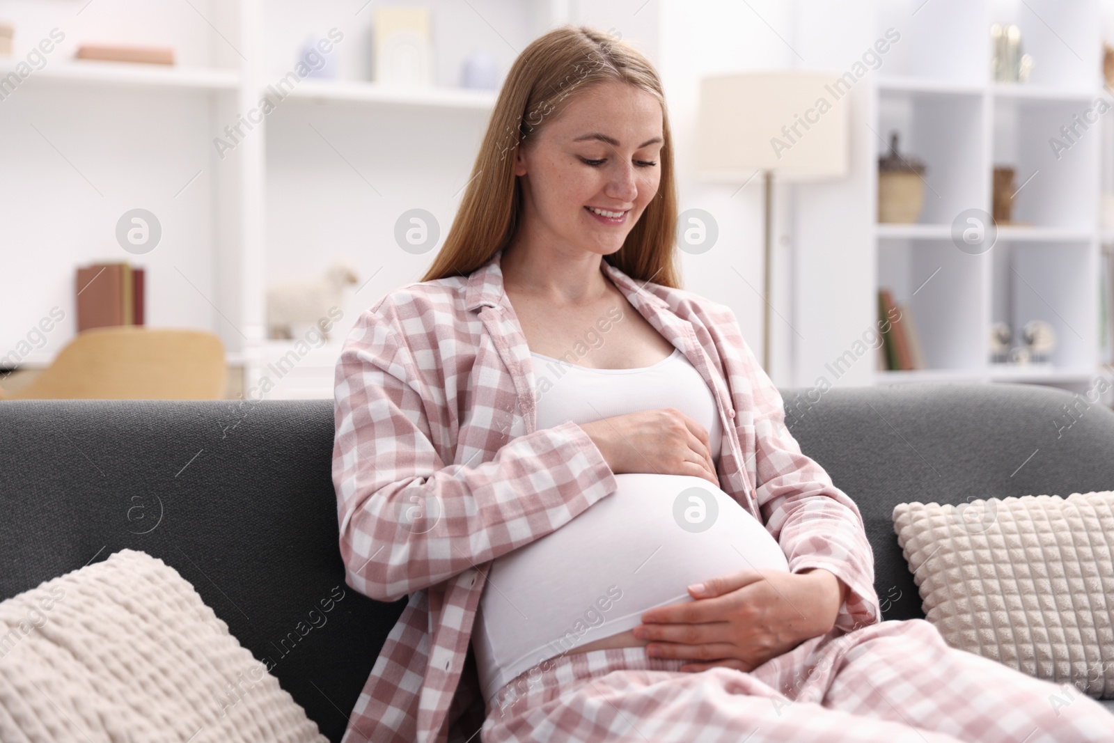 Beautiful pregnant woman on sofa at home Photo of Beautiful pregnant woman on sofa at home