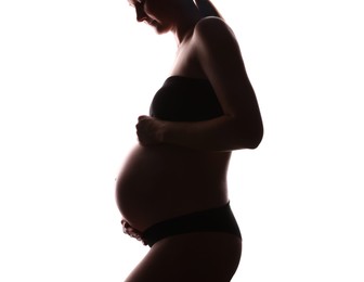 Photo of Silhouette of pregnant woman on white background, closeup
