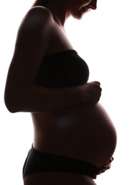 Photo of Silhouette of pregnant woman on white background, closeup