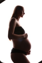 Photo of Silhouette of pregnant woman on white background
