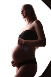 Photo of Silhouette of pregnant woman on white background