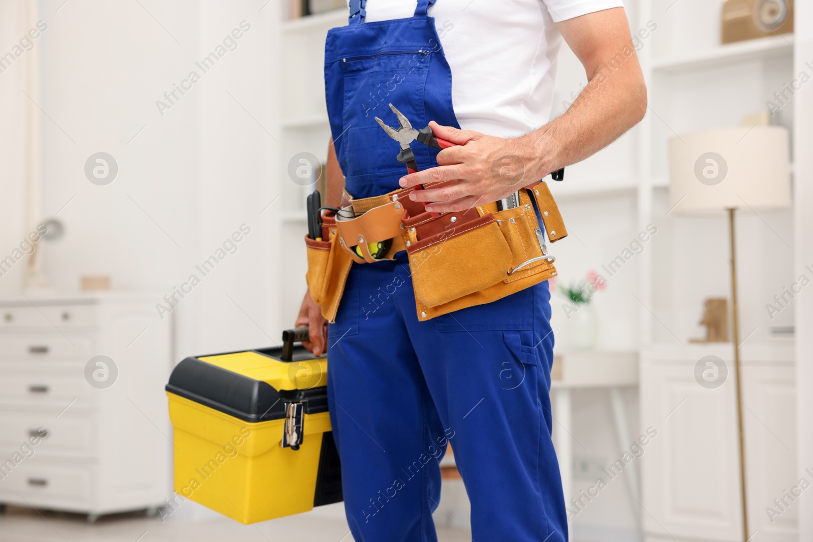 Professional repairman with tool box indoors, closeup Photo of Professional repairman with tool box indoors, closeup