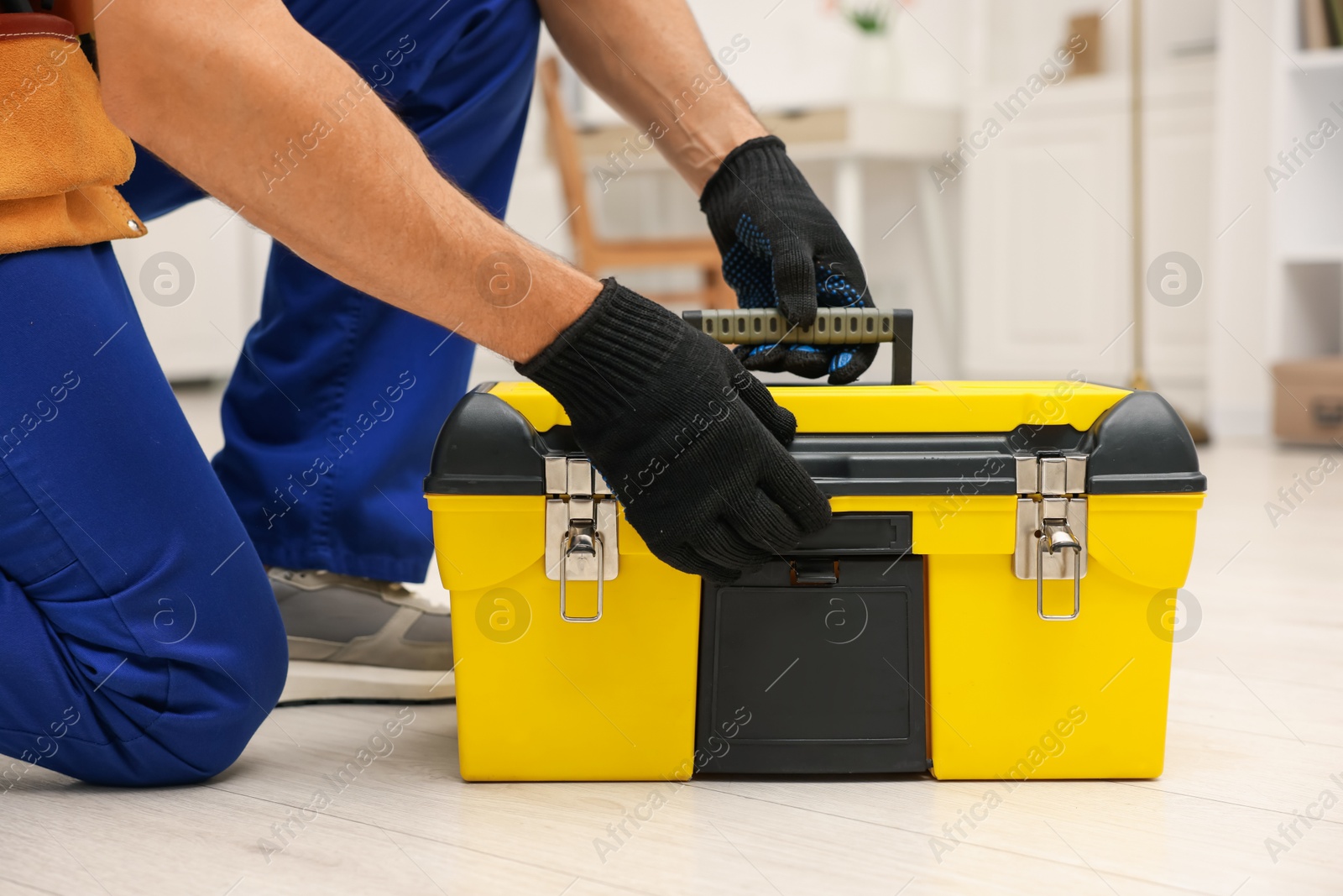 Professional repairman with tool box indoors, closeup Photo of Professional repairman with tool box indoors, closeup