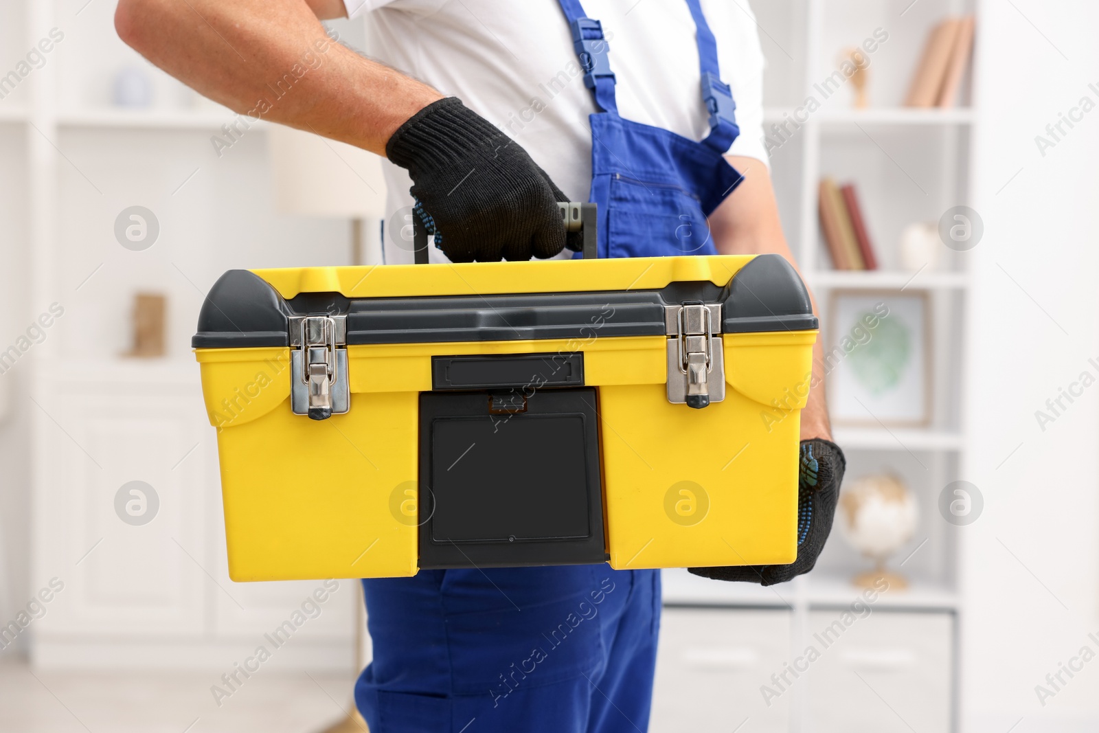 Professional repairman with tool box indoors, closeup Photo of Professional repairman with tool box indoors, closeup