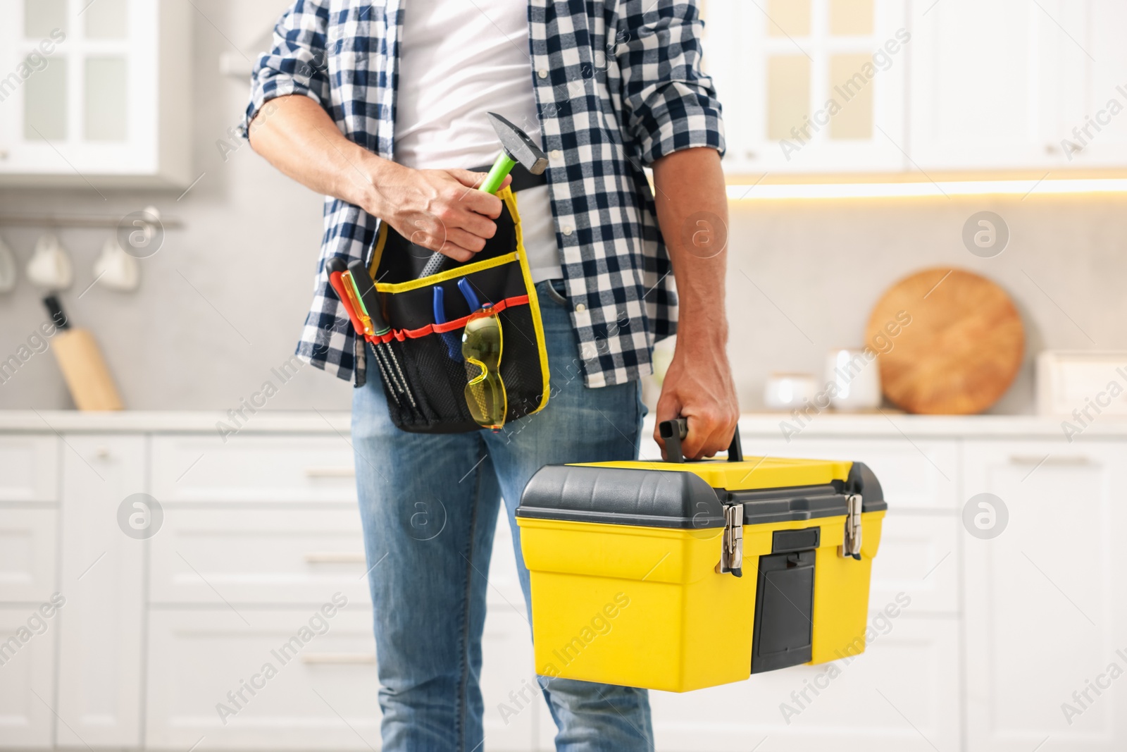 Professional repairman with tool box indoors, closeup Photo of Professional repairman with tool box indoors, closeup