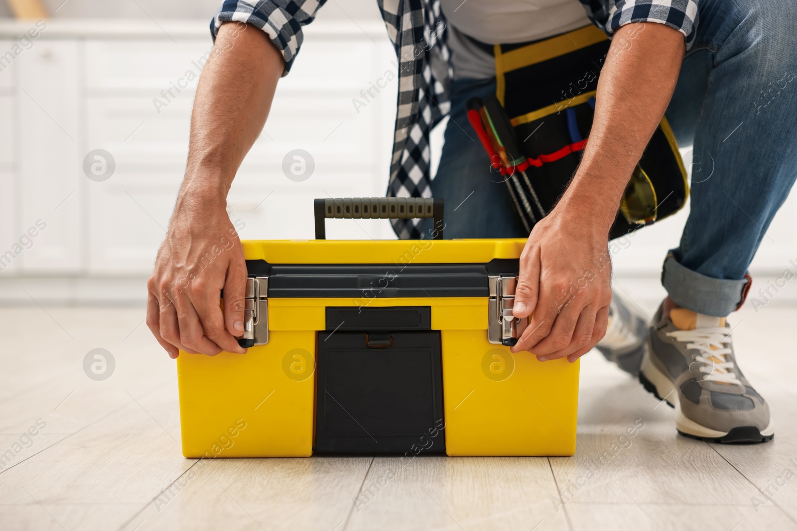 Professional repairman with tool box indoors, closeup Photo of Professional repairman with tool box indoors, closeup