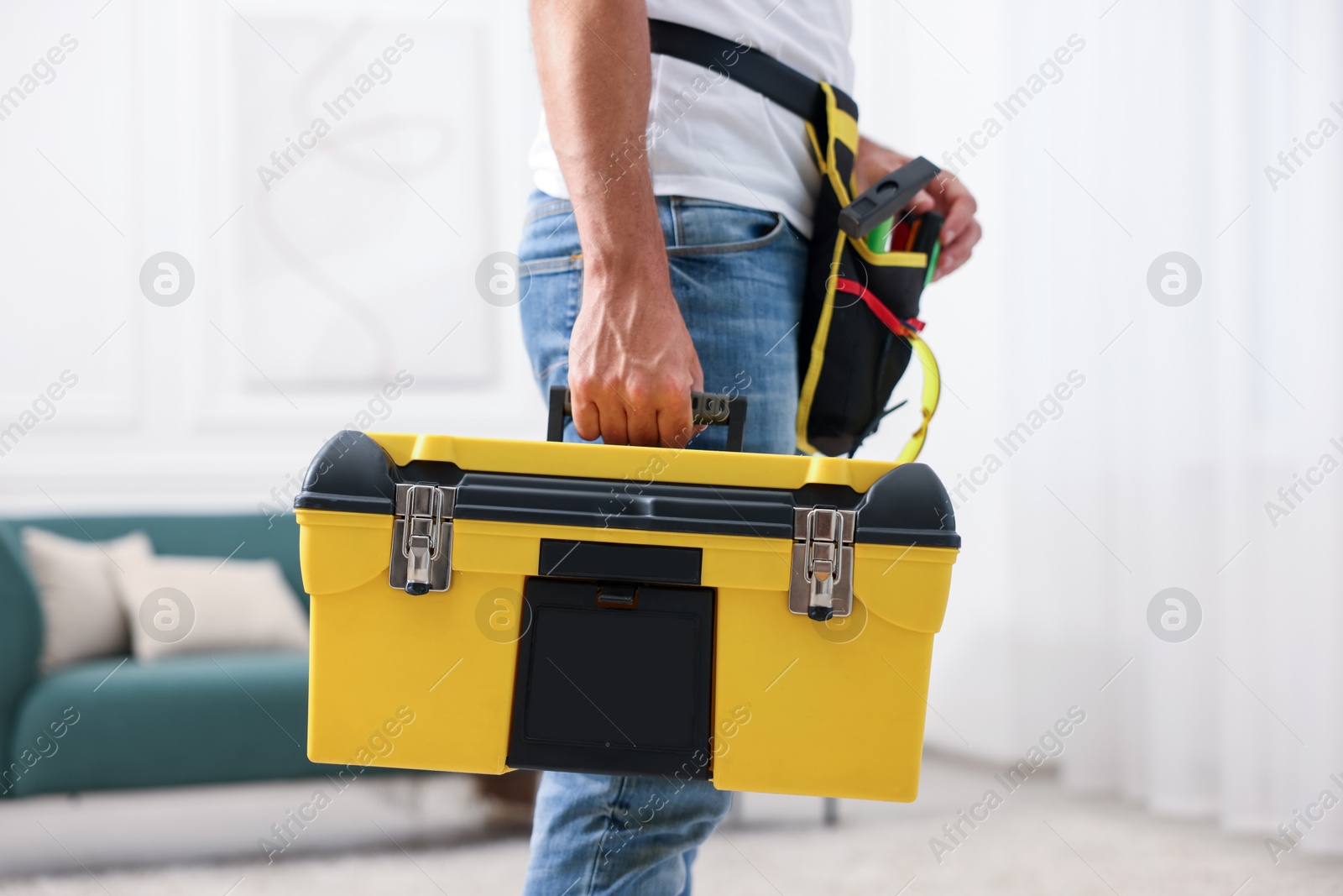 Professional repairman with tool box indoors, closeup Photo of Professional repairman with tool box indoors, closeup