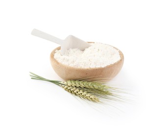 Photo of Flour in bowl and green wheat spikes isolated on white