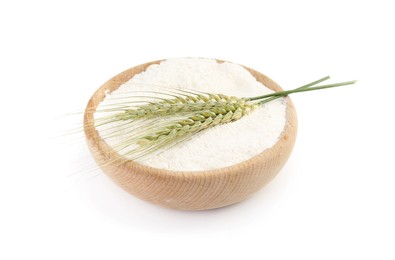 Photo of Flour in bowl and green wheat spikes isolated on white