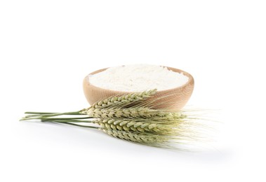 Photo of Flour in bowl and green wheat spikes isolated on white