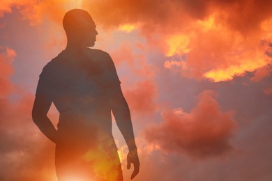 Image of Hope. Silhouette of man under beautiful sky at sunset, double exposure