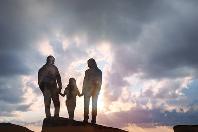 Image of Hope. Silhouette of family under beautiful sky at sunrise, double exposure