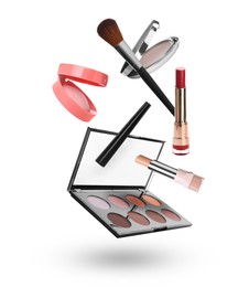 Image of Eyeshadow palette and other makeup products in air against white background