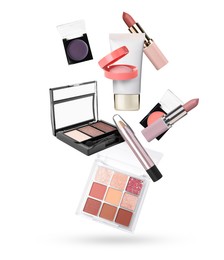 Image of Different makeup cosmetics in air against white background