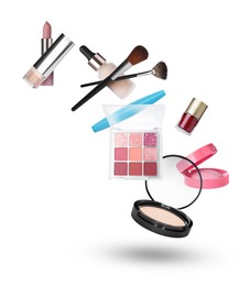 Image of Eyeshadow palette and other makeup products in air against white background