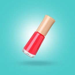Image of Red nail polish in air against light blue background