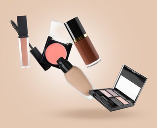 Image of Eyeshadow palette and other makeup products in air against dark beige background