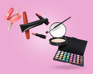 Image of Eyeshadow palette and other makeup products in air against pink background