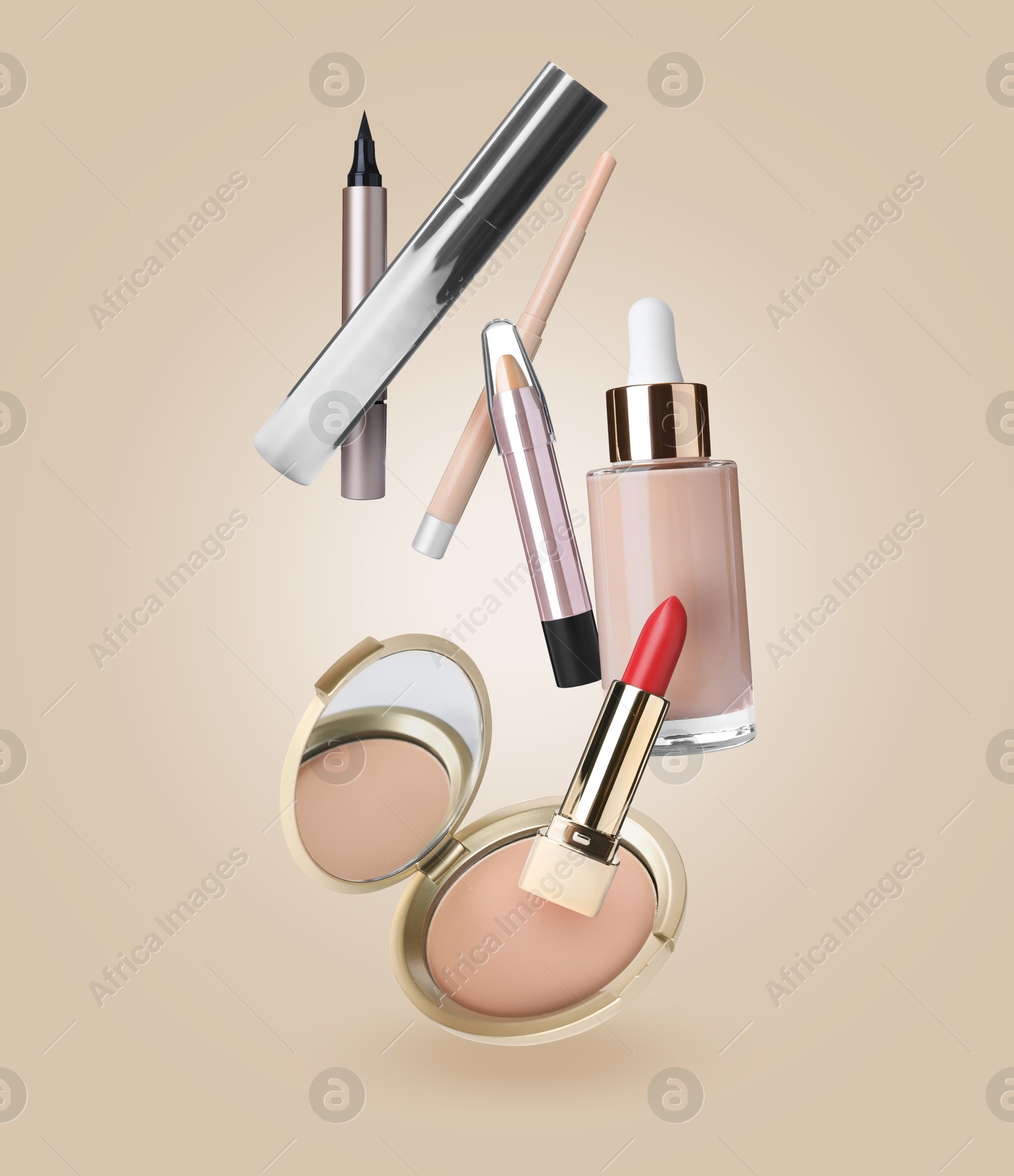 Image of Different makeup cosmetics in air against dark beige background