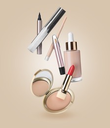 Image of Different makeup cosmetics in air against dark beige background