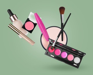 Image of Lip palette and other makeup products in air against sage color background